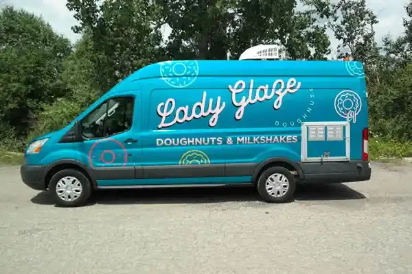 vehicle graphics on this van contain Lady Glaze Doughnuts logo and lettering of their services